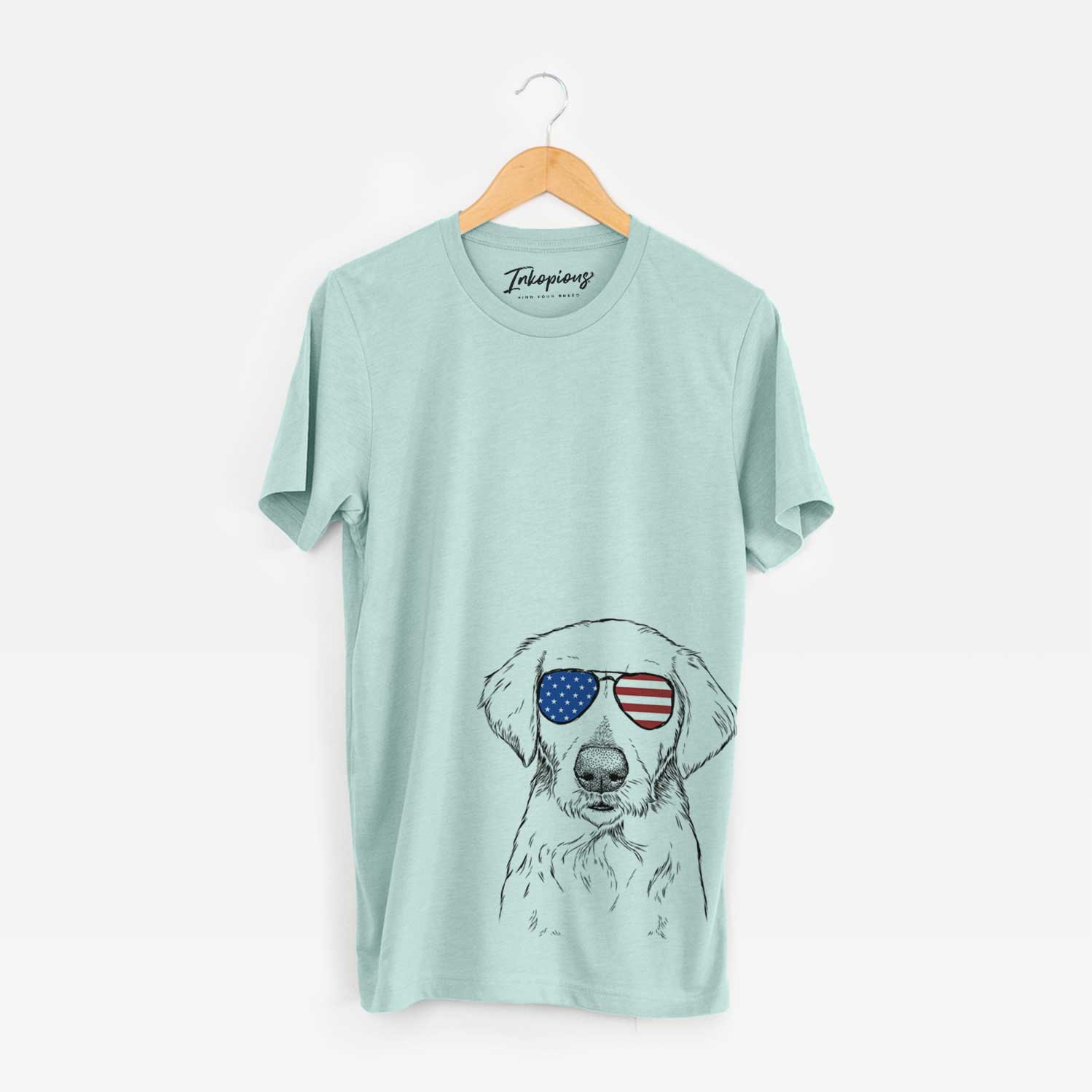 Hand-drawn sketch of Marley Sue the Labradoodle wearing American flag sunglasses on a Heather Sage Unisex crewneck