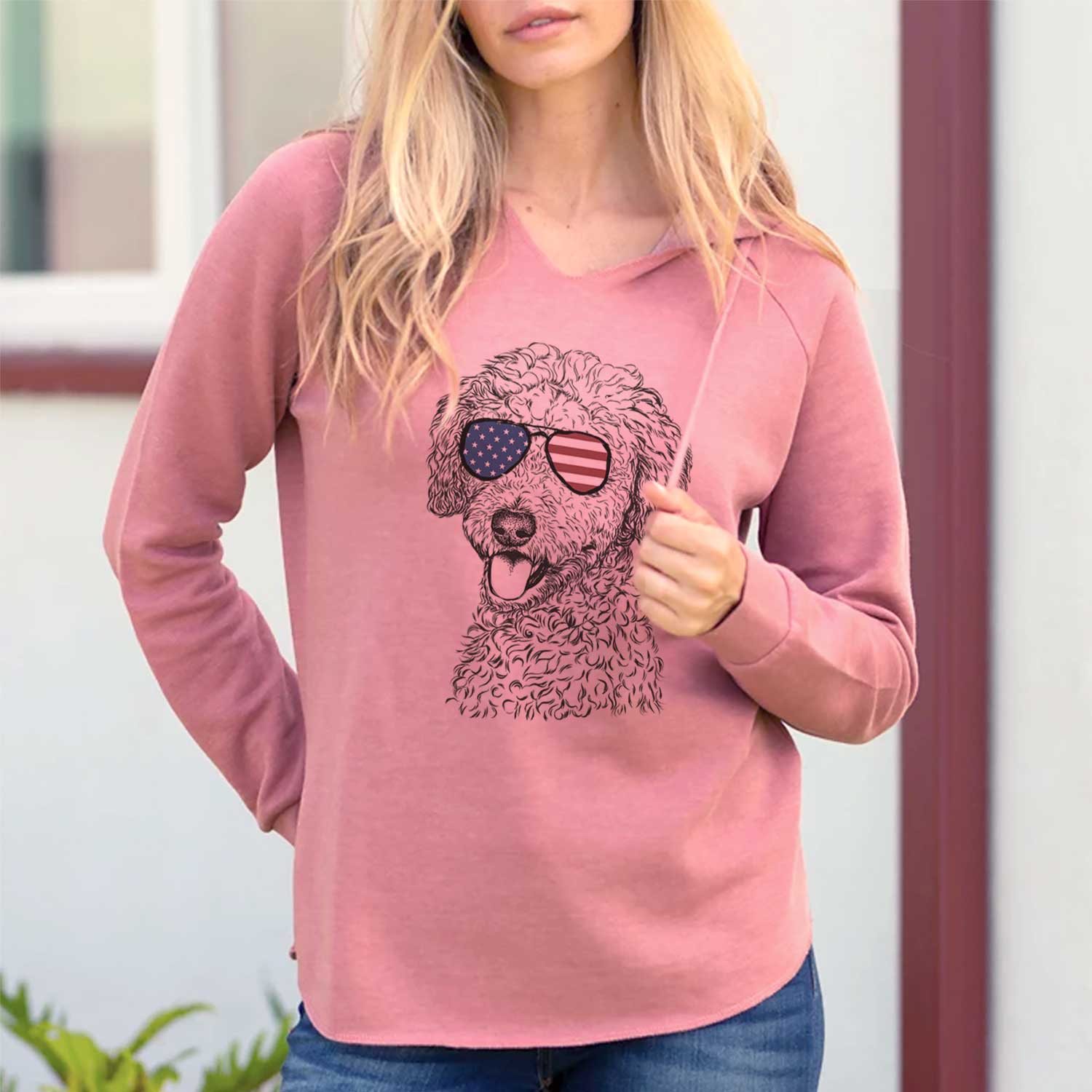 Hand-drawn sketch of Marlow the Goldendoodle wearing American flag sunglasses on a Dusty Rose Cali Wave Hooded Sweatshirt, lifestyle photo