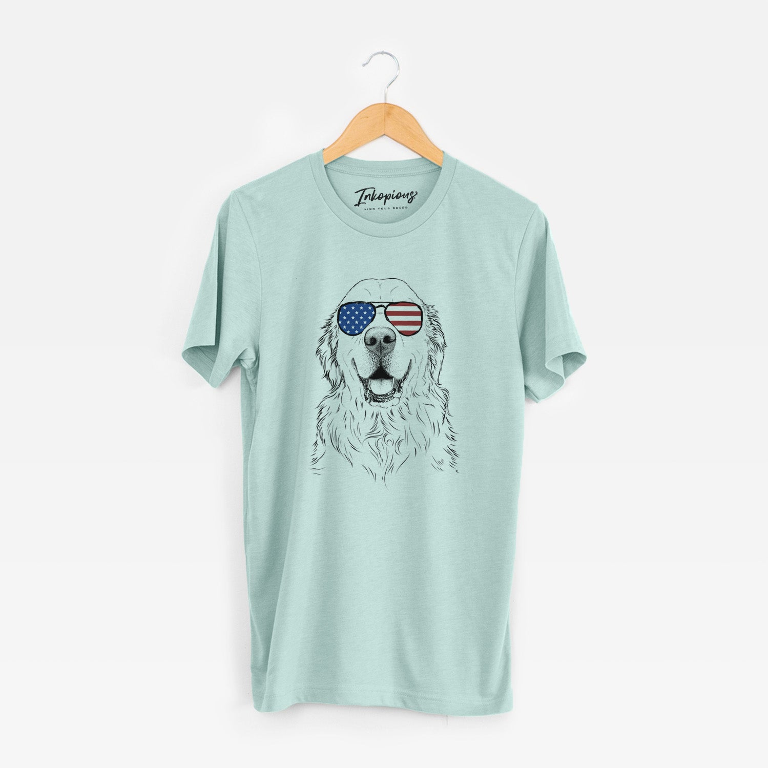 Hand-drawn sketch of Maximus the Golden Retriever wearing American flag sunglasses on a Heather Sage Unisex crewneck