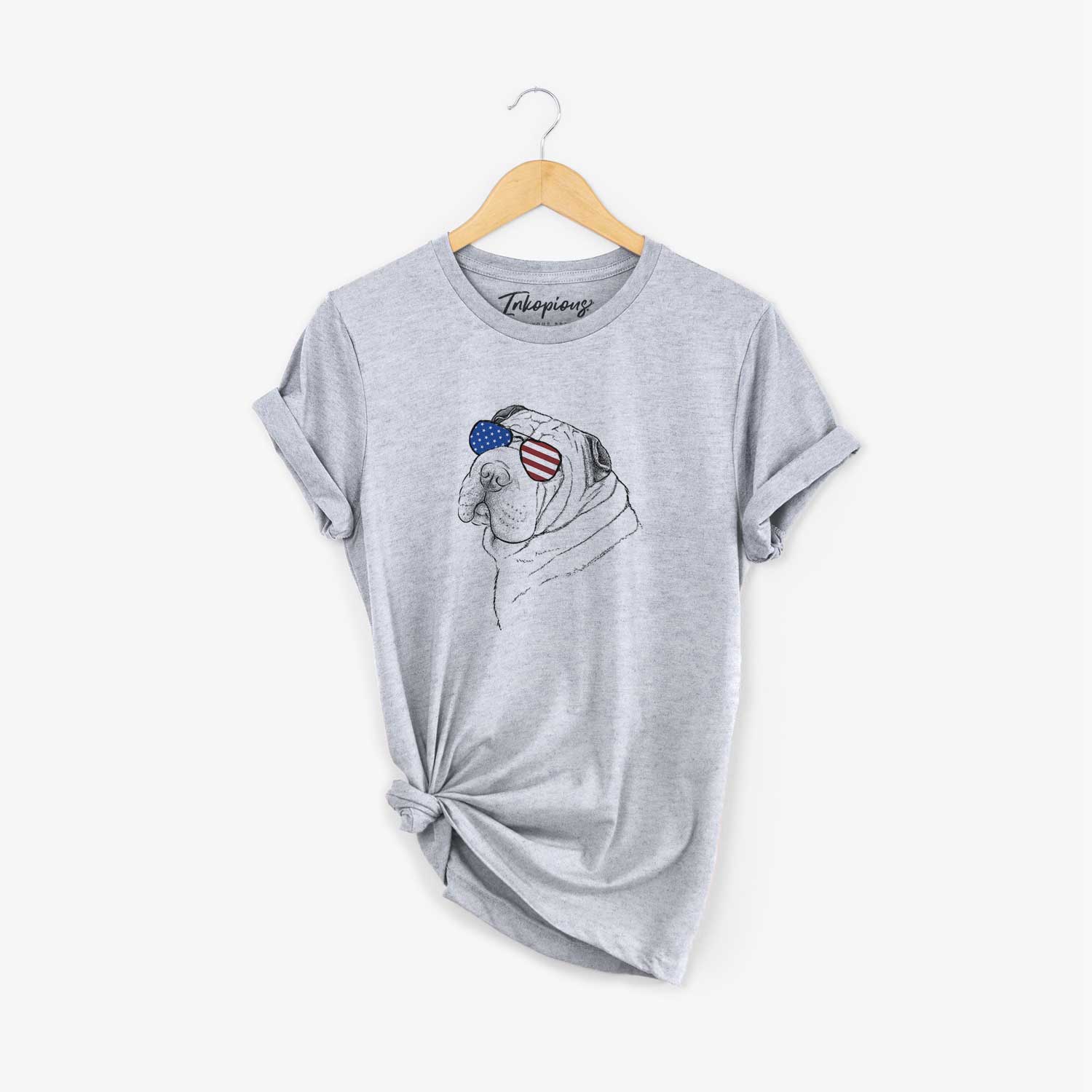 Hand-drawn sketch of Maximus the Shar Pei wearing American flag sunglasses on a Grey Unisex crewneck