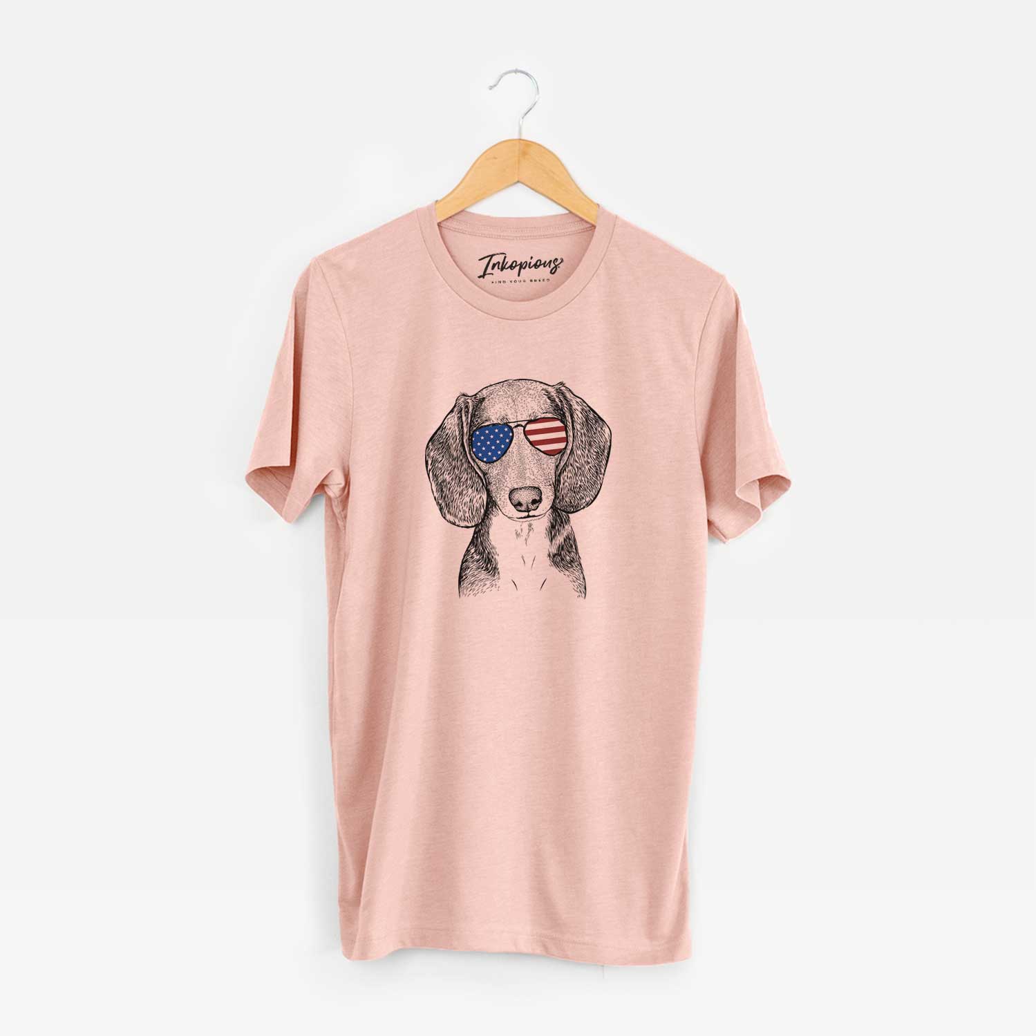 Hand-drawn sketch of Mayor Andy the Beagle wearing American flag sunglasses on a Peach Unisex crewneck