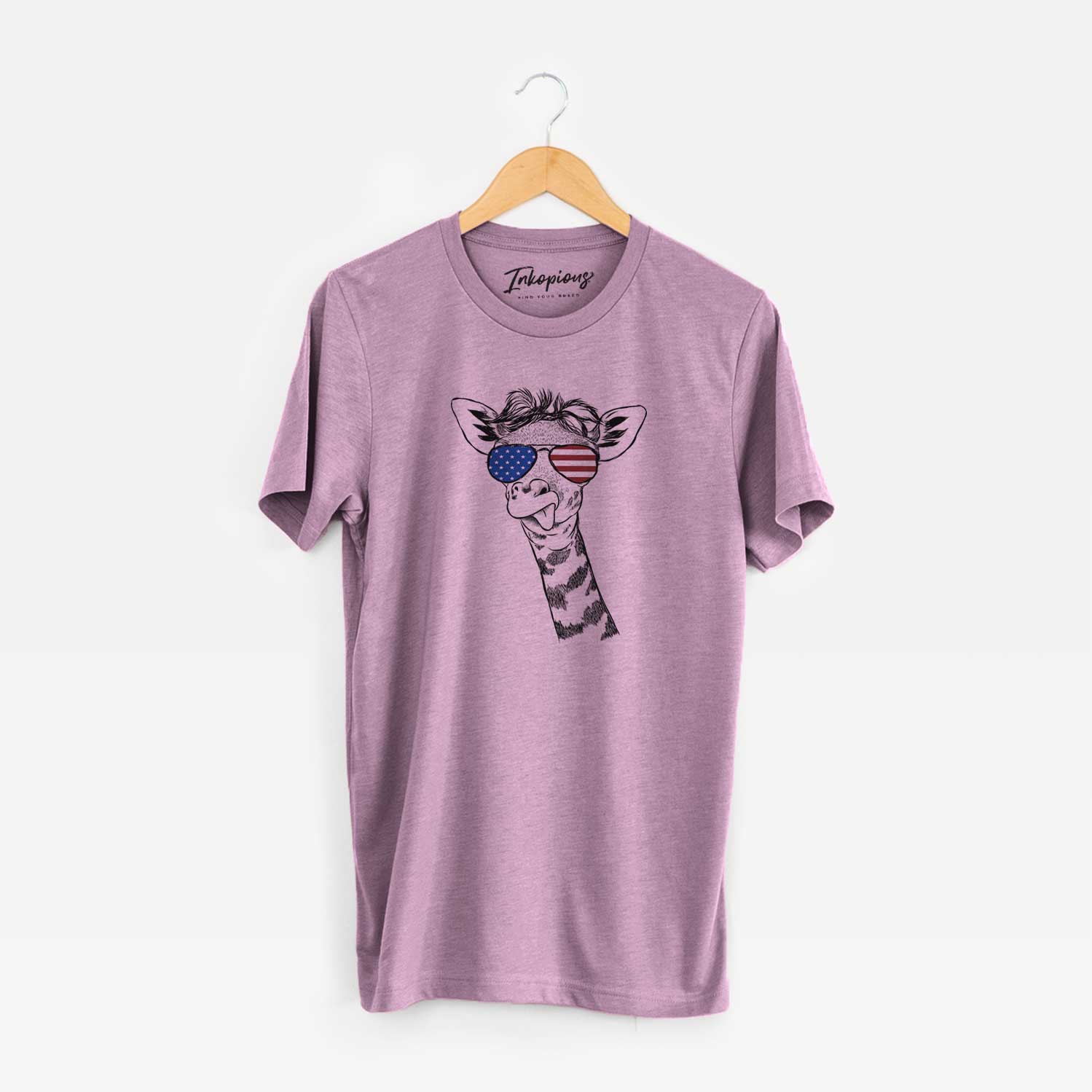 Hand-drawn sketch of Mel the Baby Giraffe wearing American flag sunglasses on an Orchid Unisex crewneck