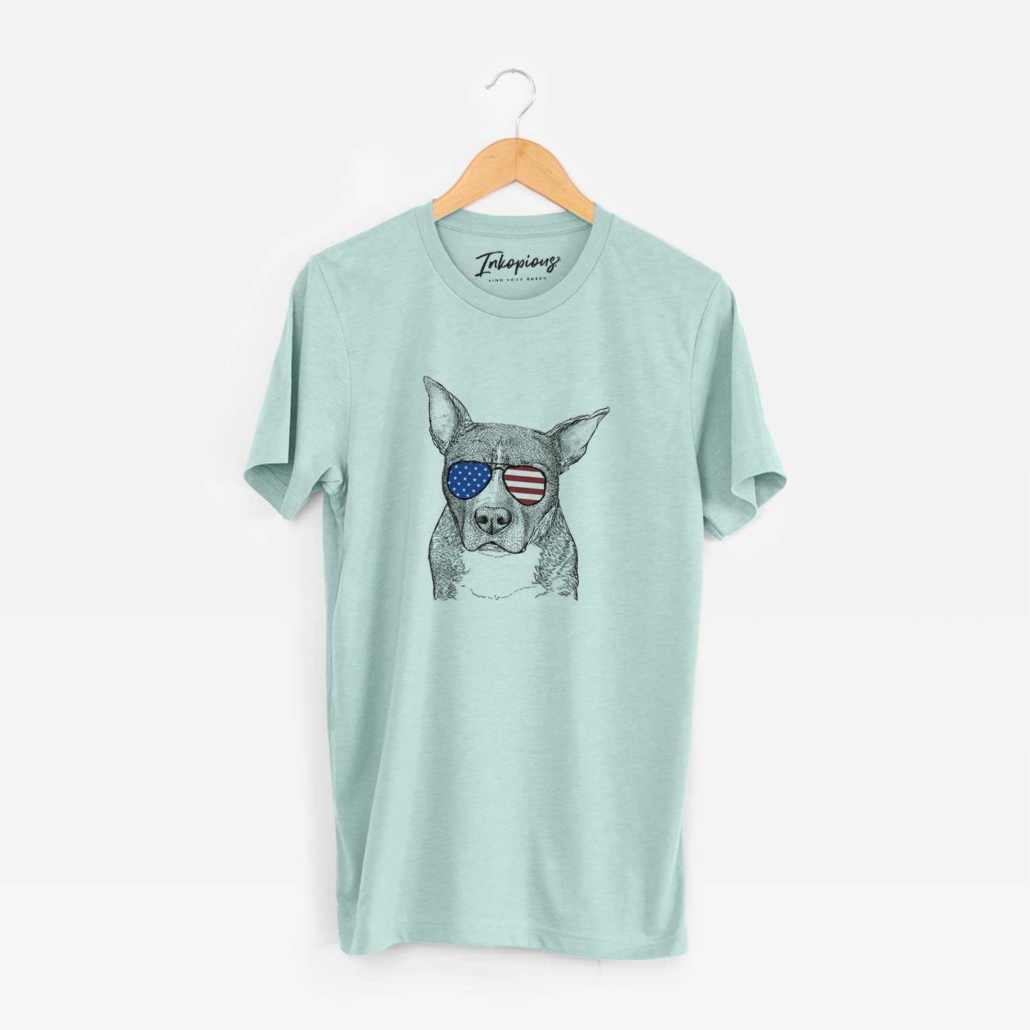 Hand-drawn sketch of Mercy the Pitbull wearing American flag sunglasses on a Heather Sage Unisex crewneck