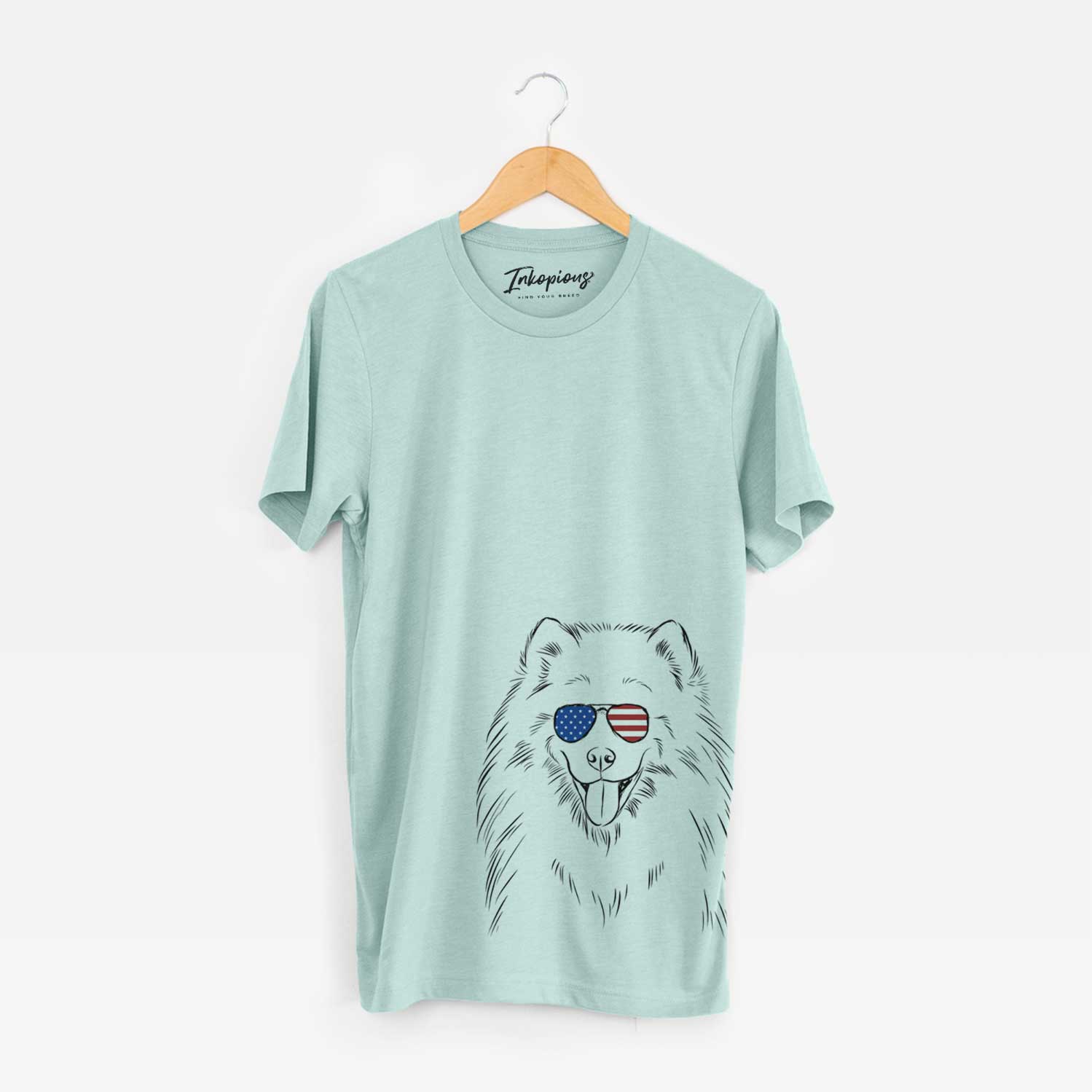 Hand-drawn sketch of Mikko the Samoyed wearing American flag sunglasses on a Heather Sage Unisex crewneck