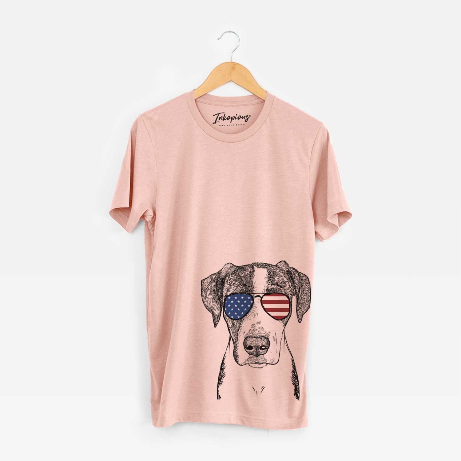 Hand-drawn sketch of Milo the Mixed Breed wearing American flag sunglasses on a Peach Unisex crewneck