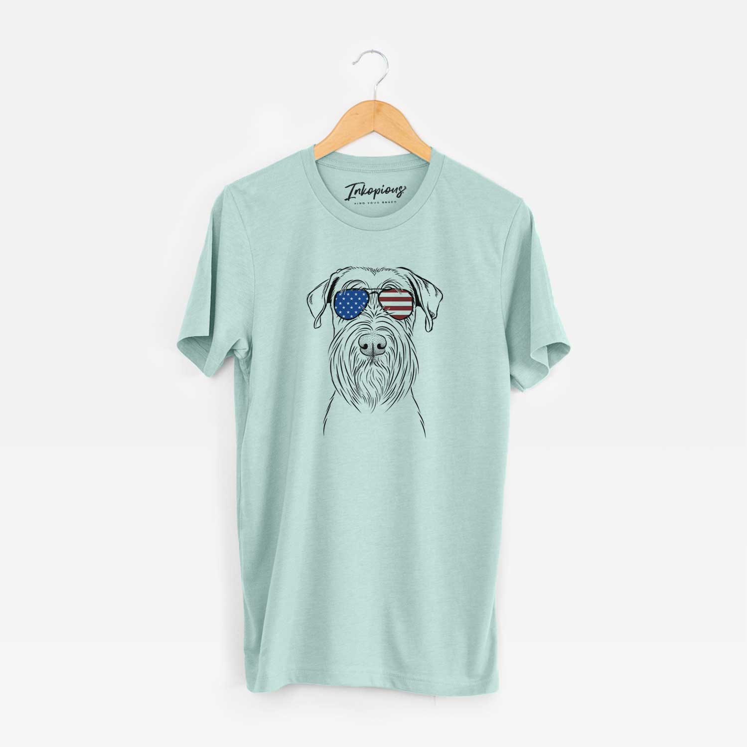 Hand-drawn sketch of Milton the Schnauzer wearing American flag sunglasses on a Heather Sage Unisex crewneck