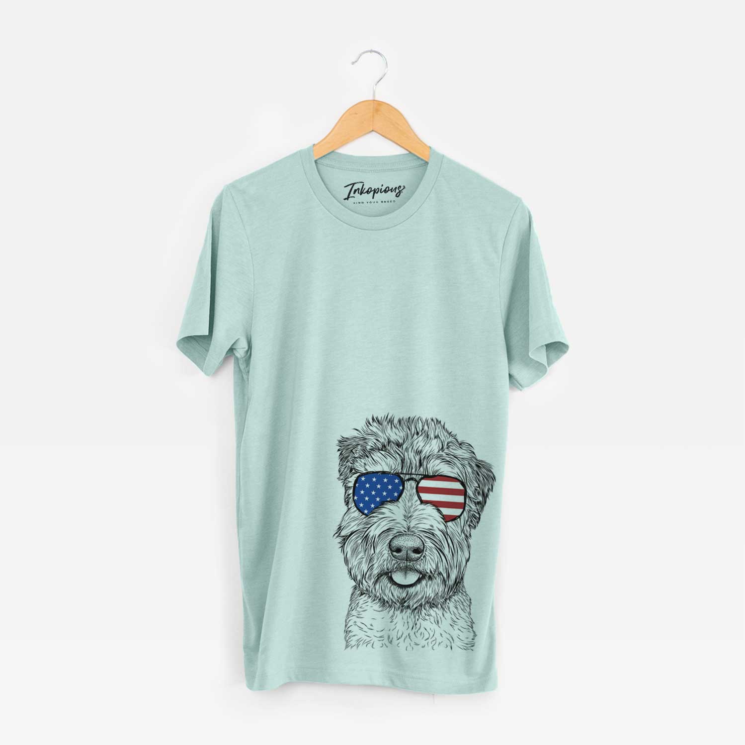 Hand-drawn sketch of Milton the Soft Coated Wheaten Terrier wearing American flag sunglasses on a Heather Sage Unisex crewneck