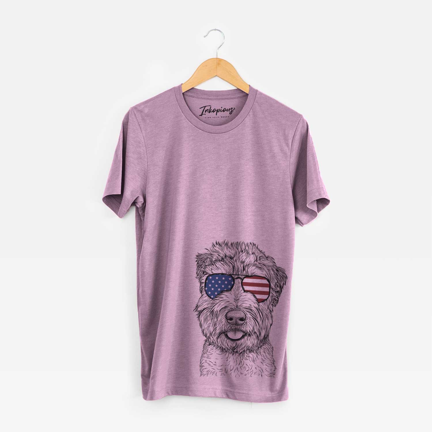 Hand-drawn sketch of Milton the Soft Coated Wheaten Terrier wearing American flag sunglasses on an Orchid Unisex crewneck