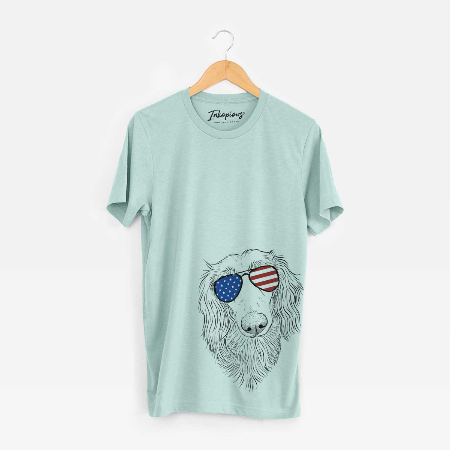 Hand-drawn sketch of Mr. Rusty the Long Haired Dachshund wearing American flag sunglasses on a Heather Sage Unisex crewneck