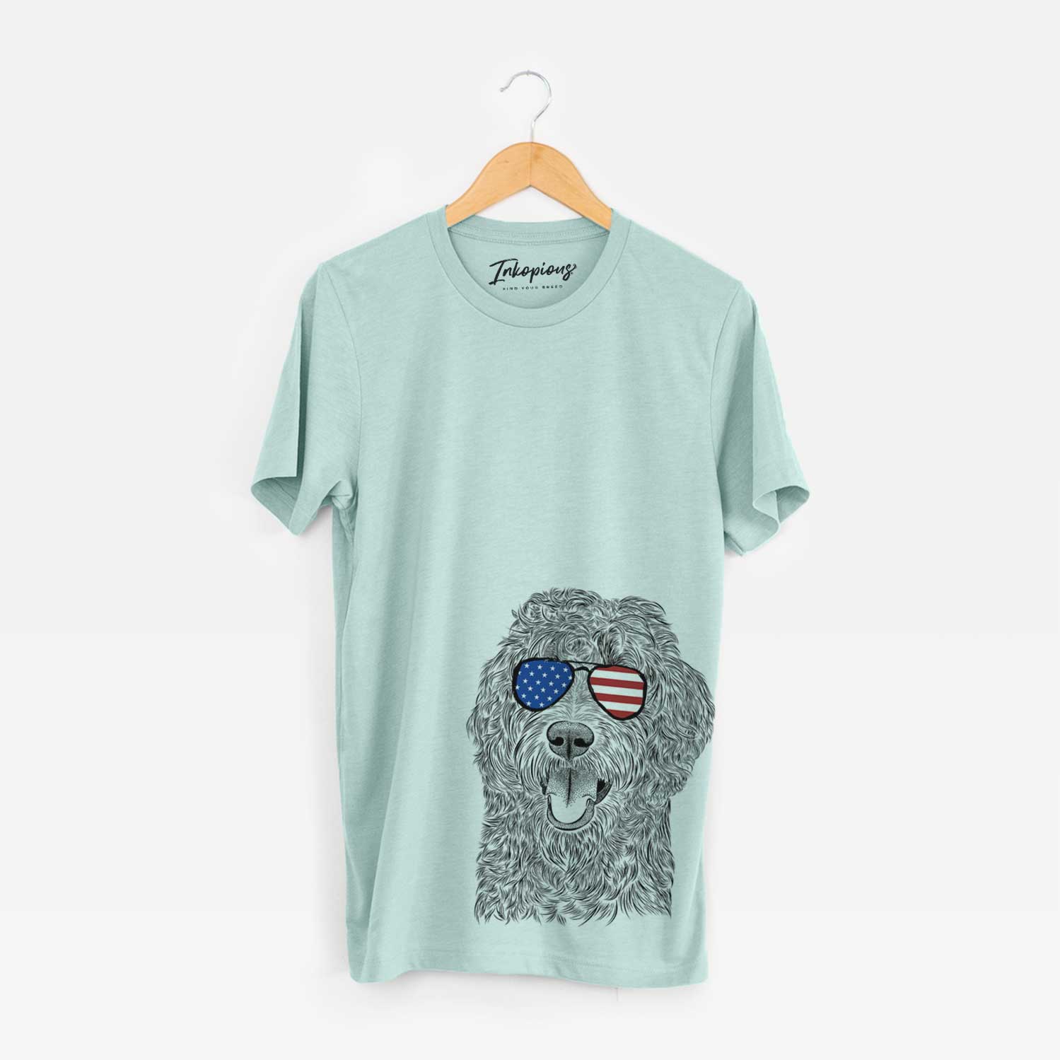 Hand-drawn sketch of Murr Dog the Labradoodle wearing American flag sunglasses on a Heather Sage Unisex crewneck