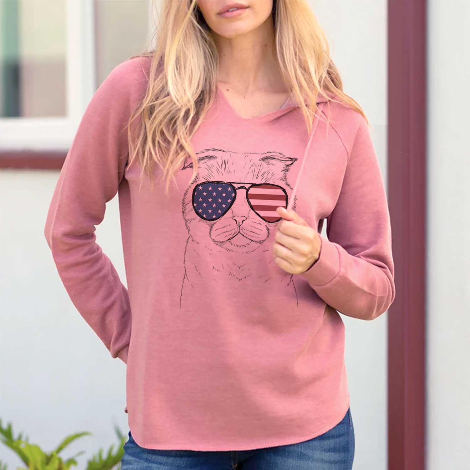 Hand-drawn sketch of Neko the Scottish Fold Cat wearing American flag sunglasses on a Dusty Rose Cali Wave Hooded Sweatshirt, lifestyle photo