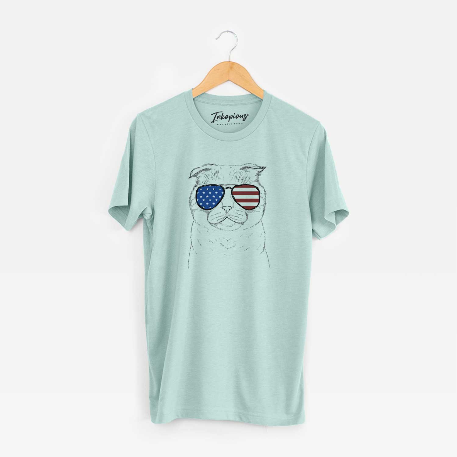 Hand-drawn sketch of Neko the Scottish Fold Cat wearing American flag sunglasses on a Heather Sage Unisex crewneck