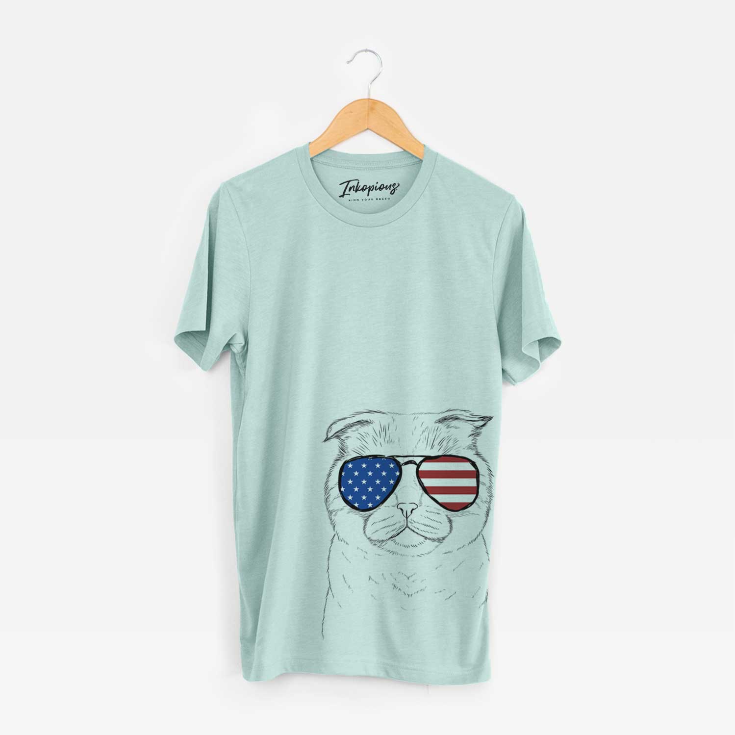 Hand-drawn sketch of Neko the Scottish Fold Cat wearing American flag sunglasses on a Heather Sage Unisex crewneck