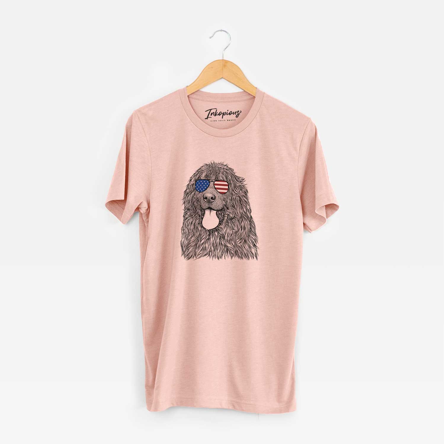 Hand-drawn sketch of Neptune the Newfoundland wearing American flag sunglasses on a Peach Unisex crewneck