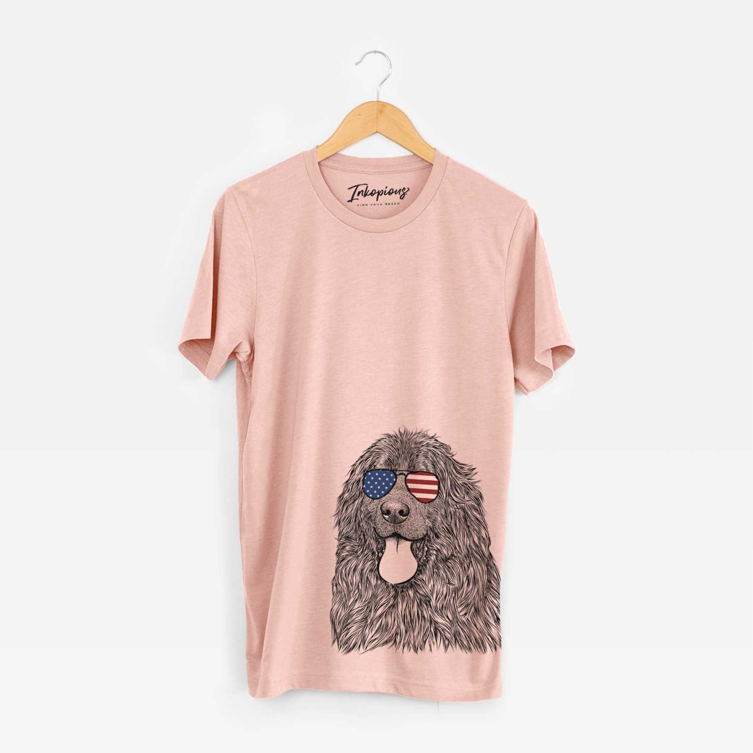 Hand-drawn sketch of Neptune the Newfoundland wearing American flag sunglasses on a Peach Unisex crewneck