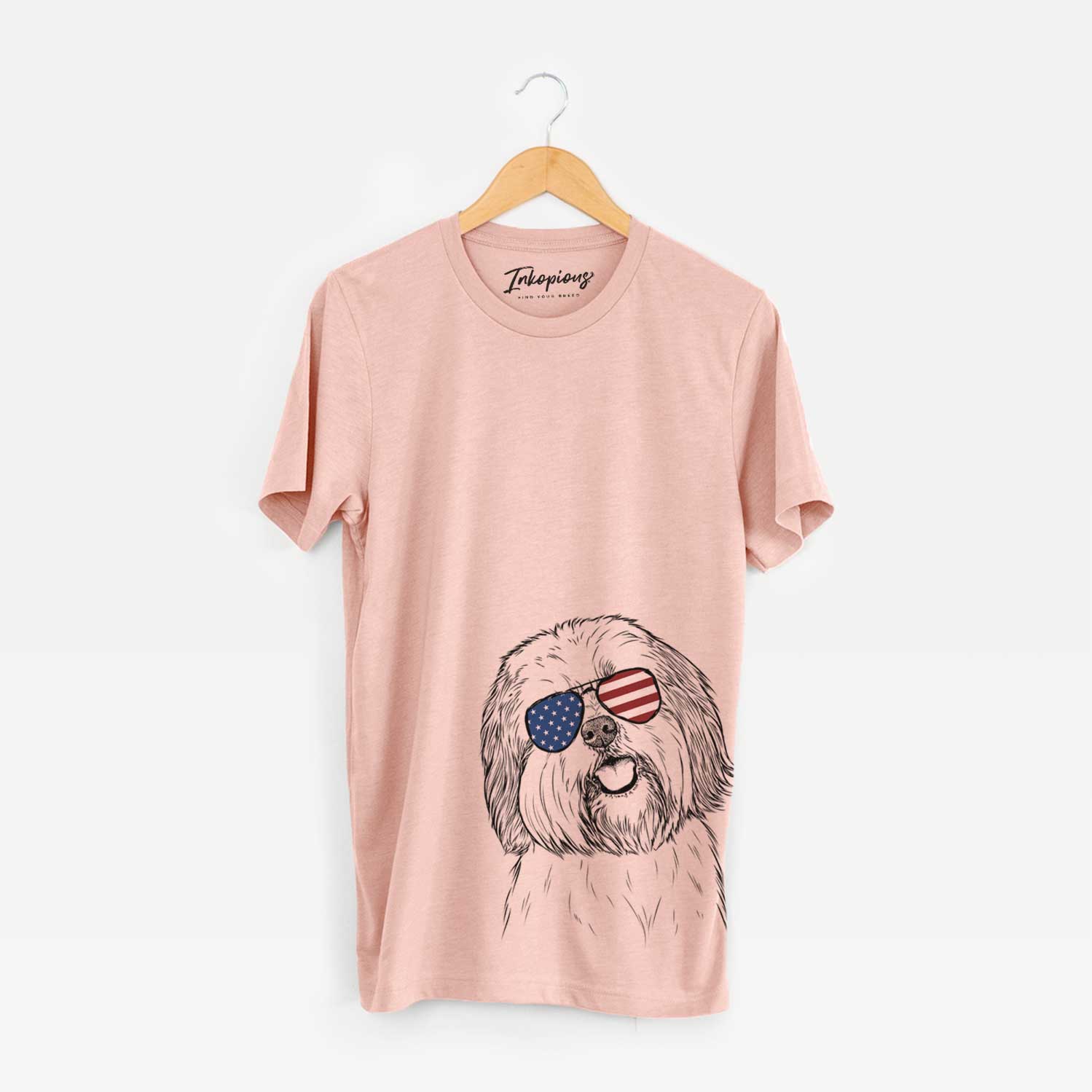 Hand-drawn sketch of Nikka the Lowchen wearing American flag sunglasses on a Peach Unisex crewneck