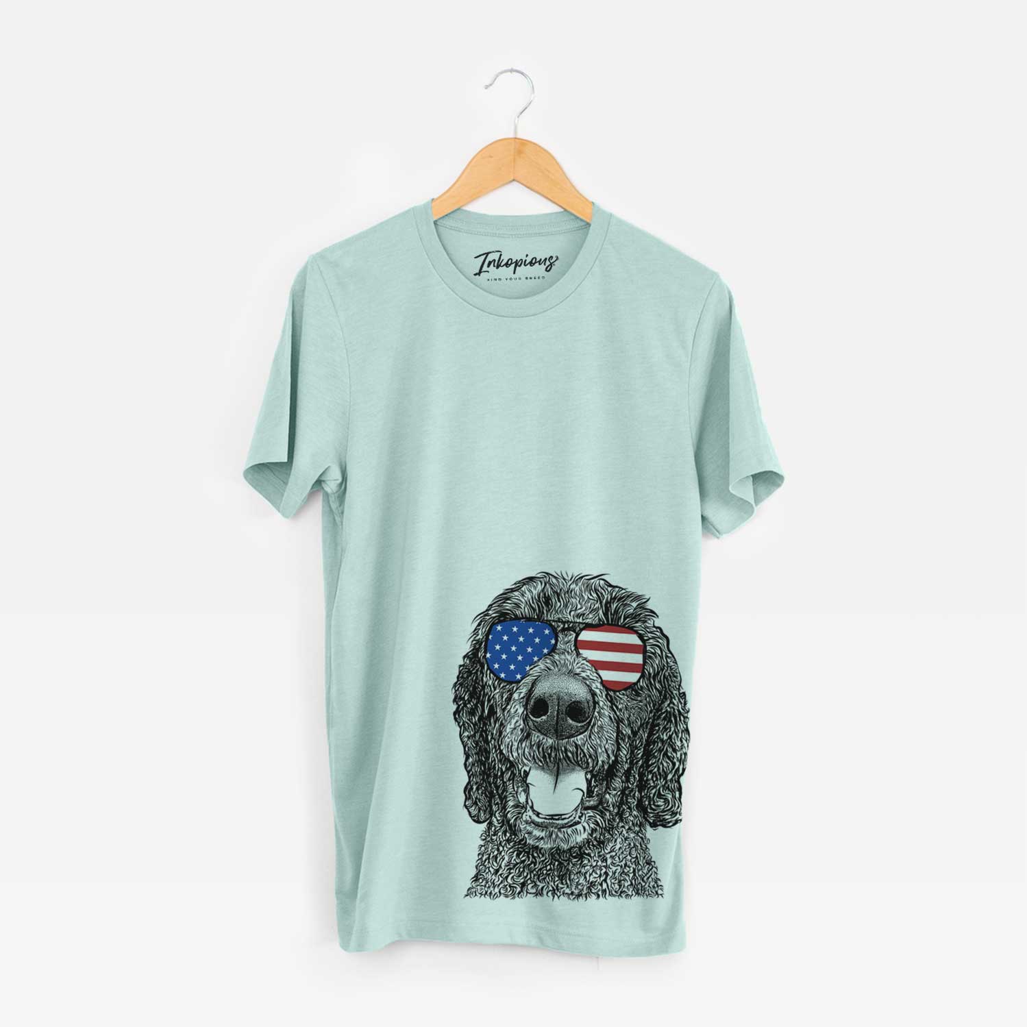 Hand-drawn sketch of Obi James the Goldendoodle wearing American flag sunglasses on a Heather Sage Unisex crewneck