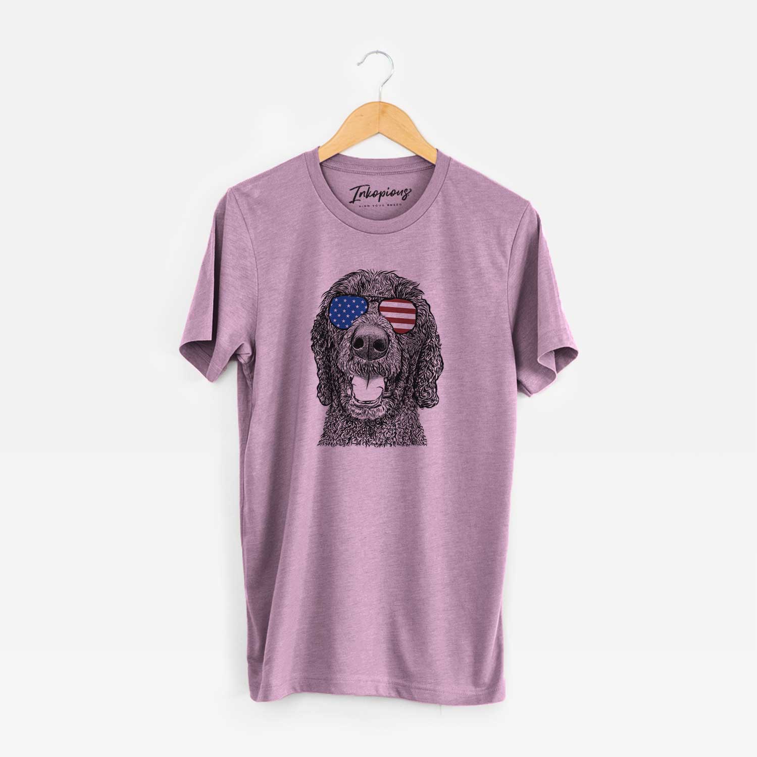 Hand-drawn sketch of Obi James the Goldendoodle wearing American flag sunglasses on an Orchid Unisex crewneck