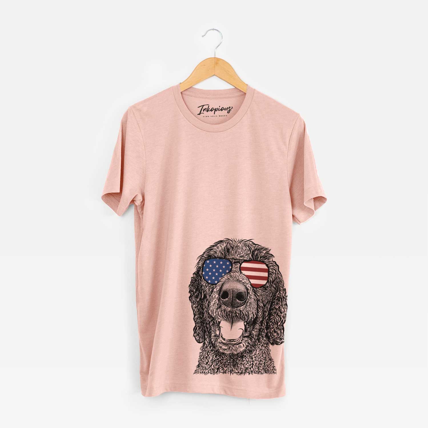 Hand-drawn sketch of Obi James the Goldendoodle wearing American flag sunglasses on a Peach Unisex crewneck
