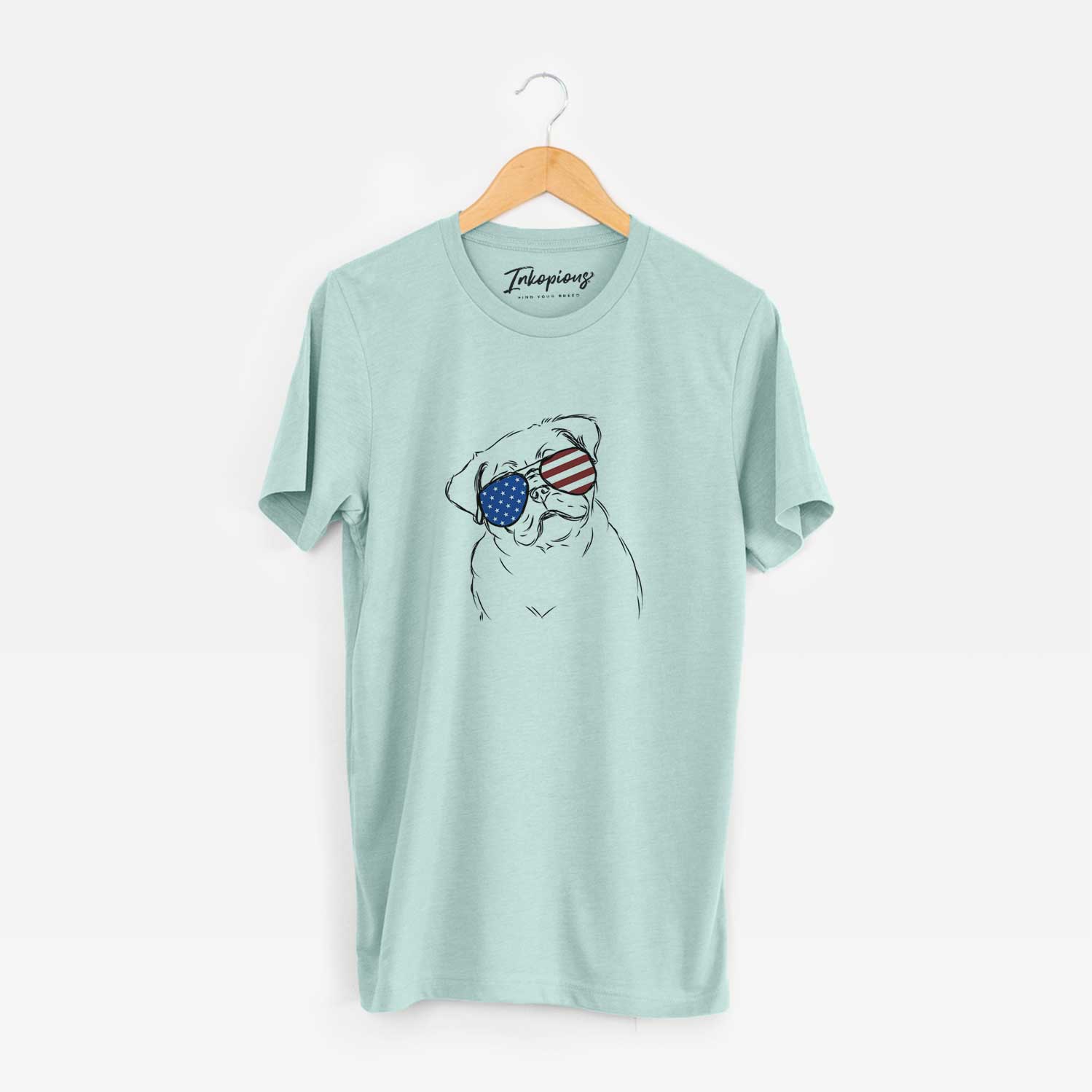 Hand-drawn sketch of Otis the Pug wearing American flag sunglasses on a Heather Sage Unisex crewneck