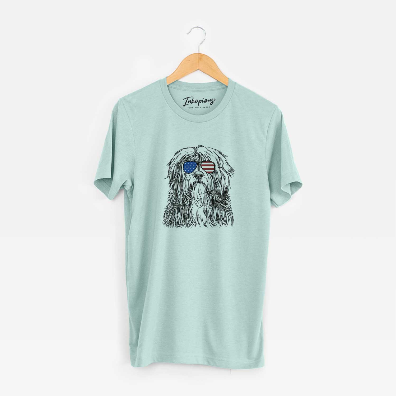Hand-drawn sketch of Otto the Polish Lowland Sheepdog wearing American flag sunglasses on a Heather Sage Unisex crewneck