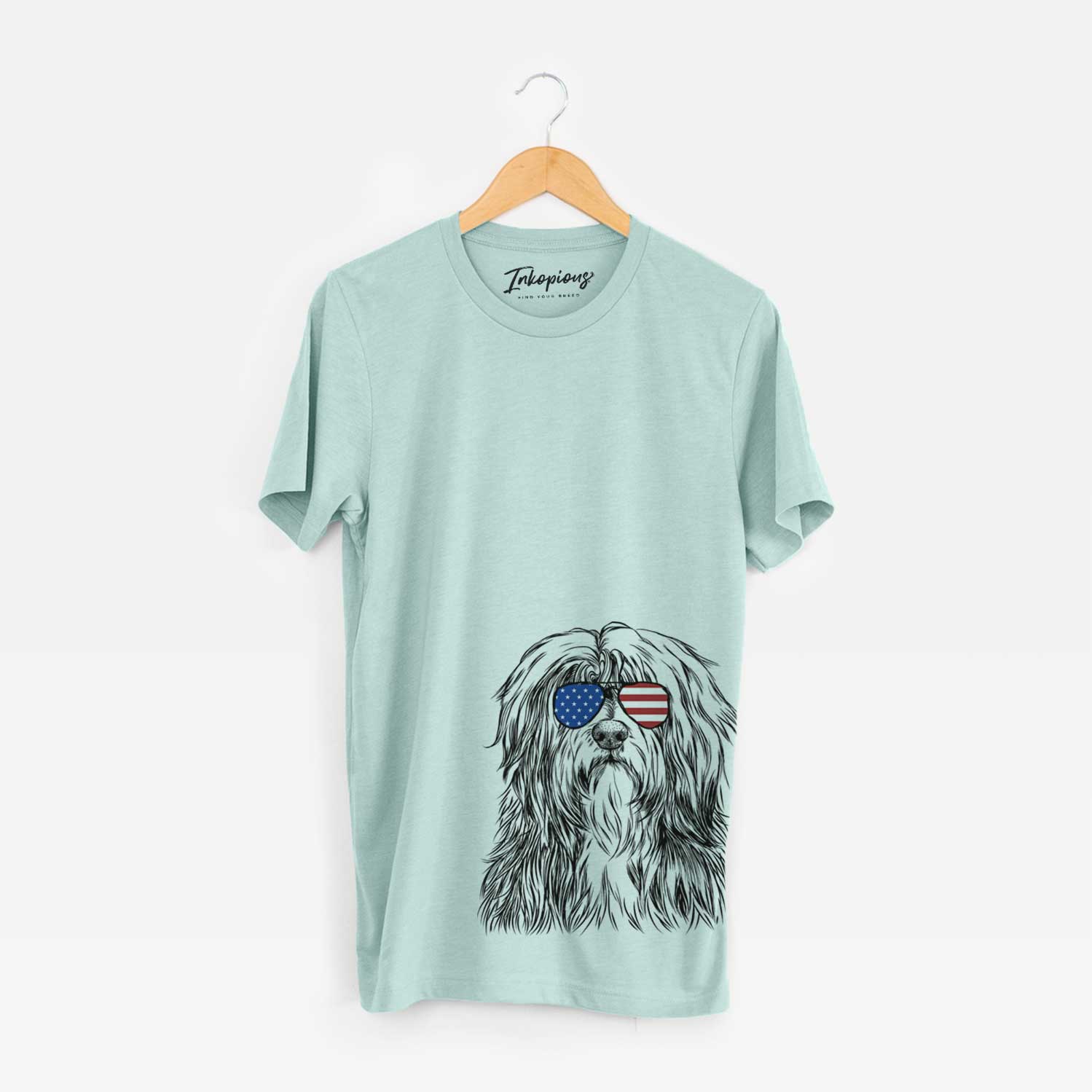 Hand-drawn sketch of Otto the Polish Lowland Sheepdog wearing American flag sunglasses on a Heather Sage Unisex crewneck