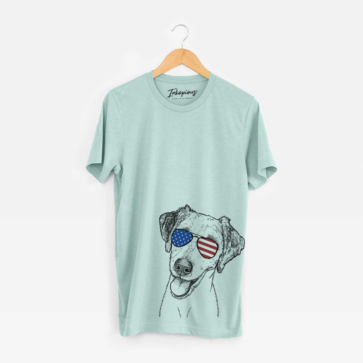 Hand-drawn sketch of Palm Palm the Aussiedoodle wearing American flag sunglasses on a Heather Sage Unisex crewneck