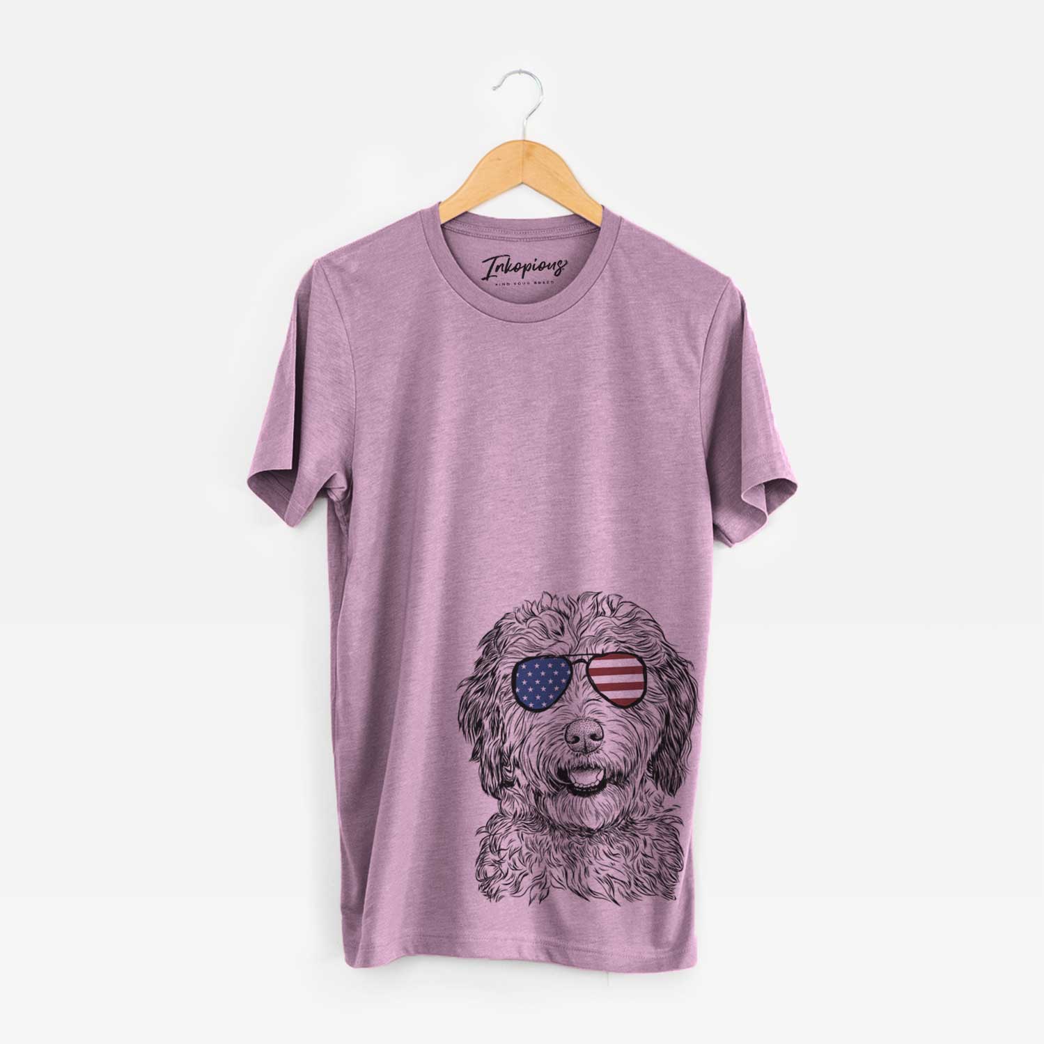 Hand-drawn sketch of Palmer the Aussiedoodle wearing American flag sunglasses on an Orchid Unisex crewneck