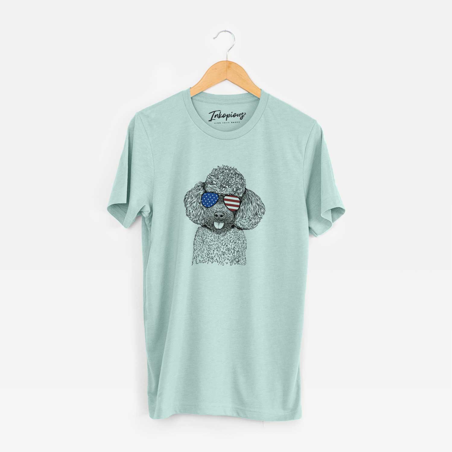 Hand-drawn sketch of George the Toy Poodle wearing American flag sunglasses on a Heather Sage Unisex crewneck