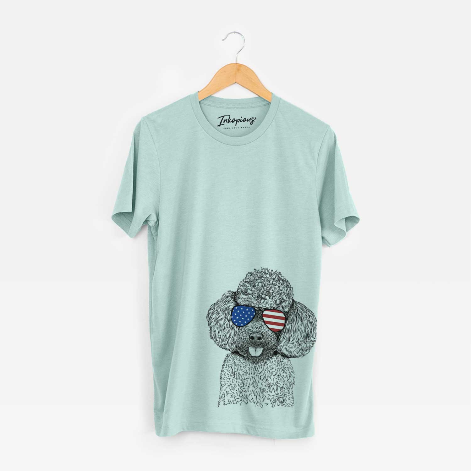 Hand-drawn sketch of George the Toy Poodle wearing American flag sunglasses on a Heather Sage Unisex crewneck