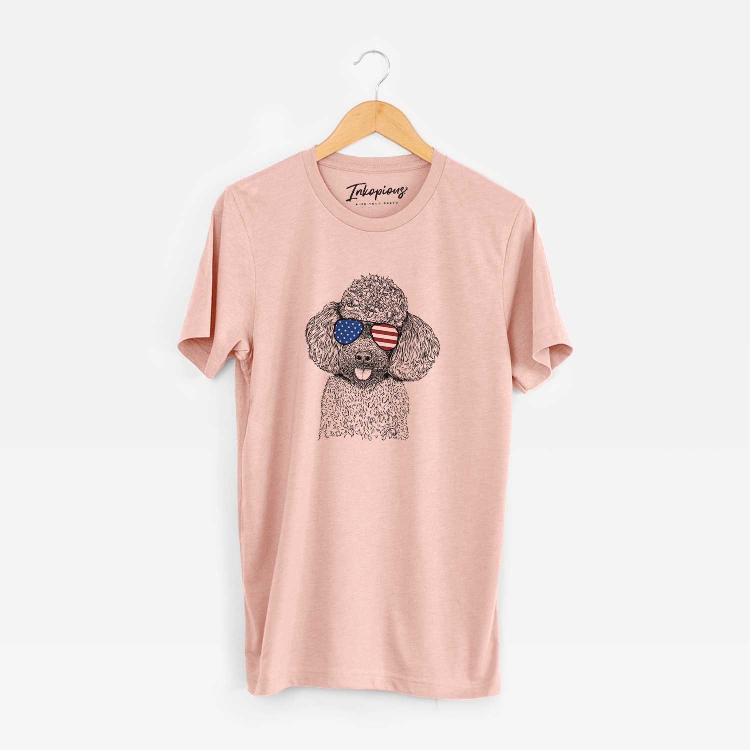 Hand-drawn sketch of George the Toy Poodle wearing American flag sunglasses on a Peach Unisex crewneck