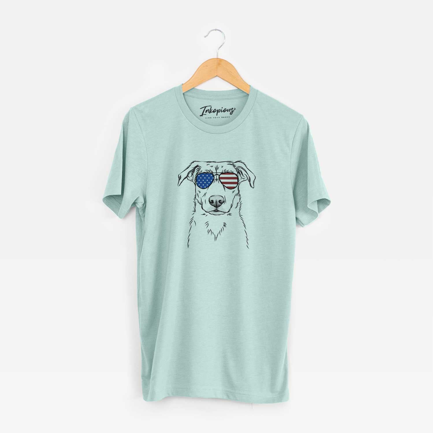 Hand-drawn sketch of Peanut the Lab Mix wearing American flag sunglasses on a Heather Sage Unisex crewneck