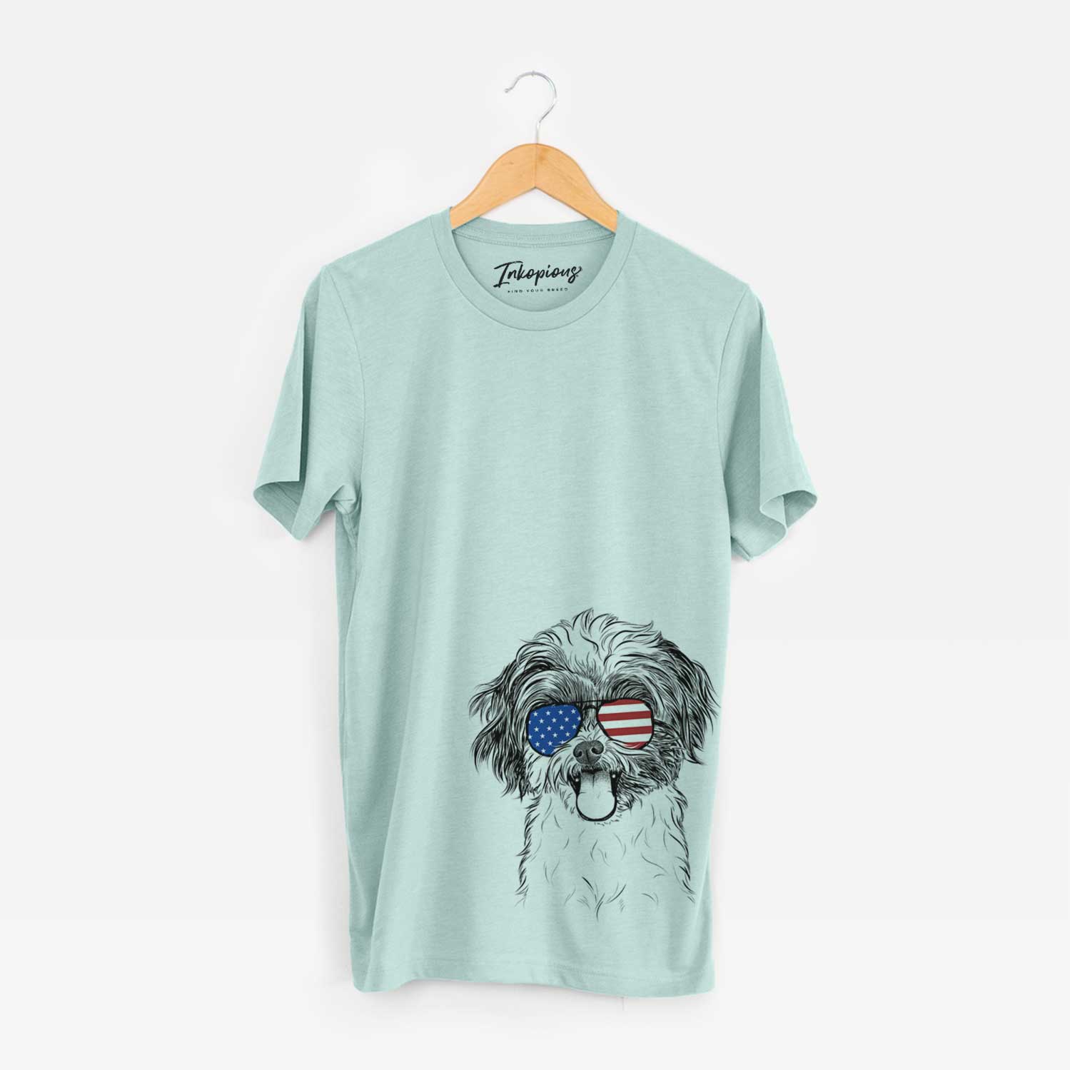 Hand-drawn sketch of Pepper the Shihpoo wearing American flag sunglasses on a Heather Sage Unisex crewneck