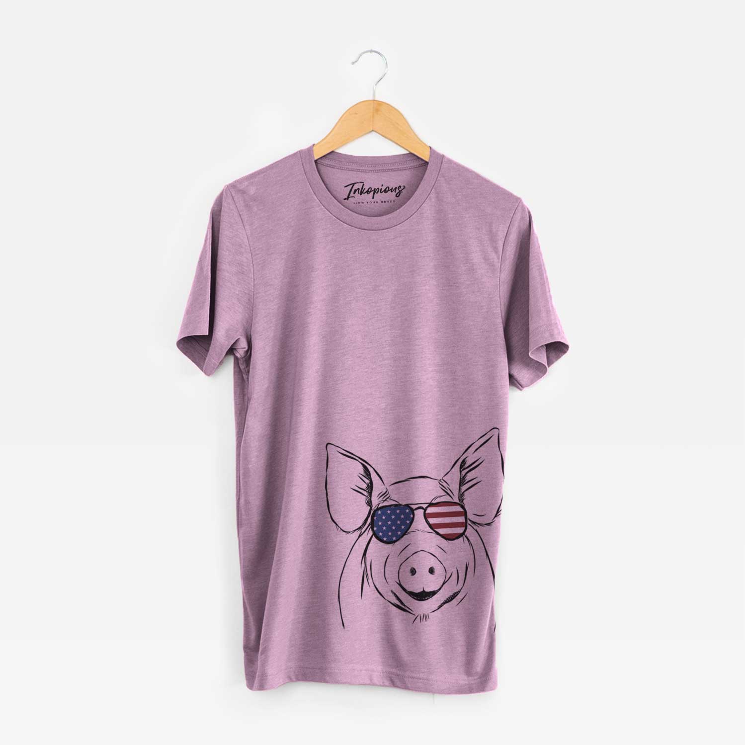 Hand-drawn sketch of Perry the Pig wearing American flag sunglasses on an Orchid Unisex crewneck
