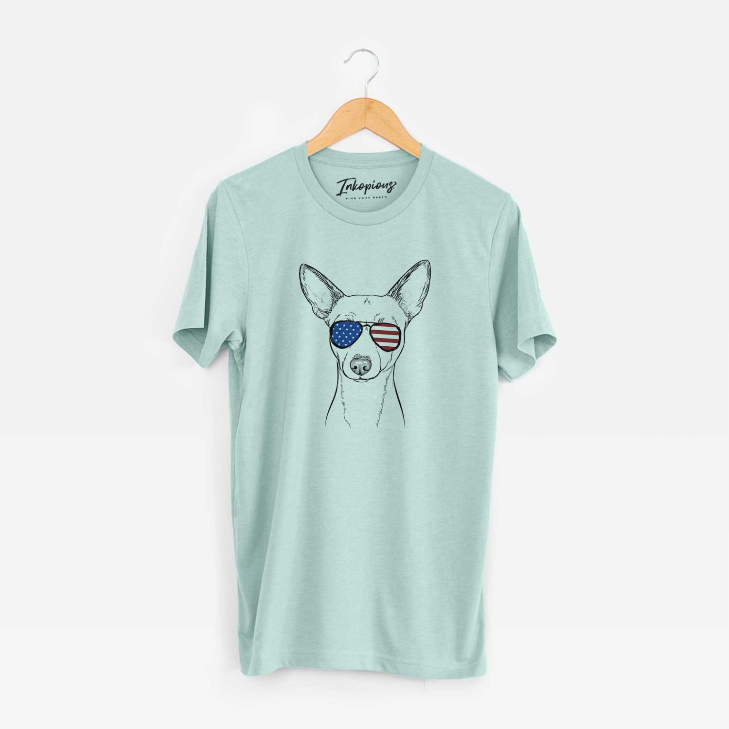 Hand-drawn sketch of Perry the Portuguese Podengo wearing American flag sunglasses on a Heather Sage Unisex crewneck