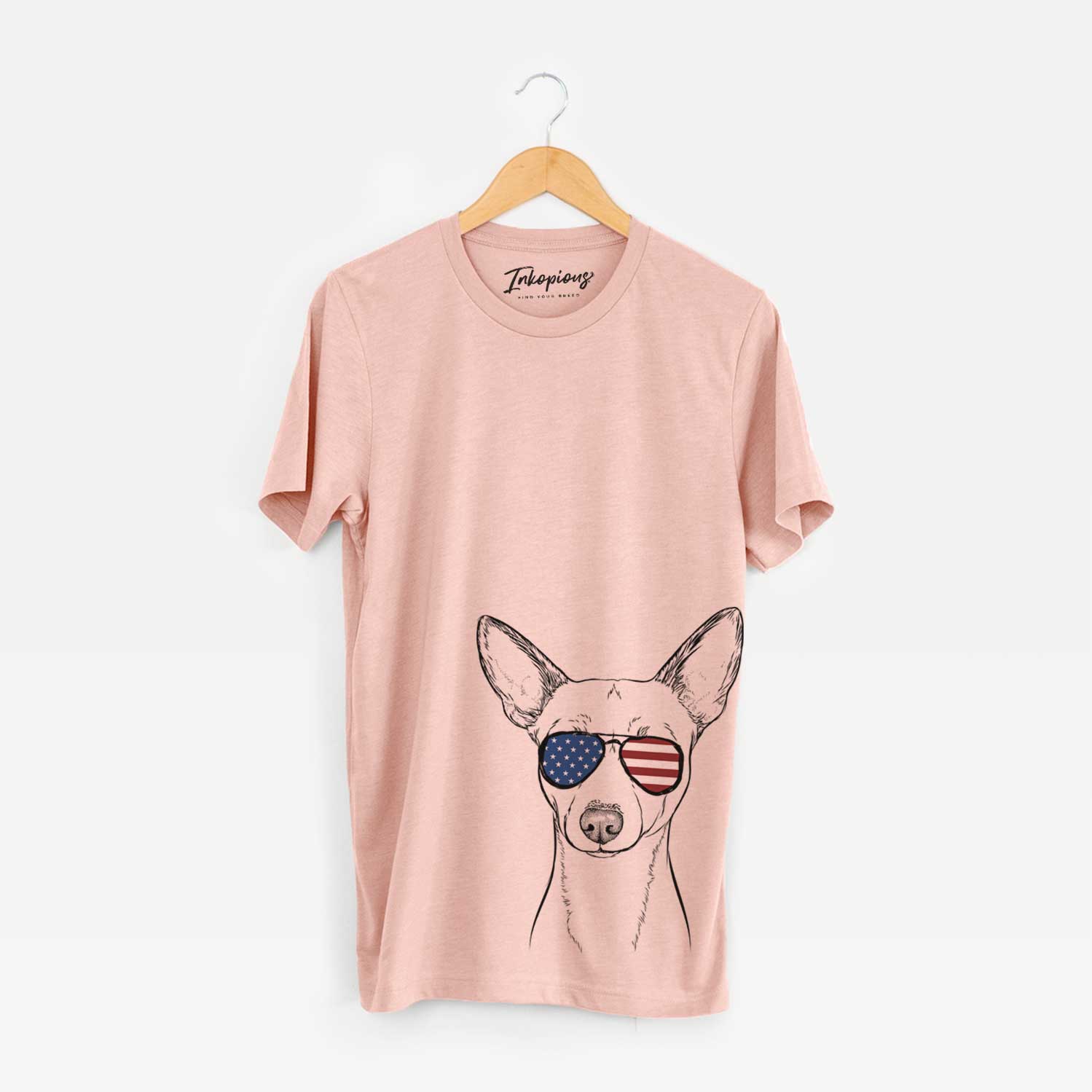 Hand-drawn sketch of Perry the Portuguese Podengo wearing American flag sunglasses on a Peach Unisex crewneck