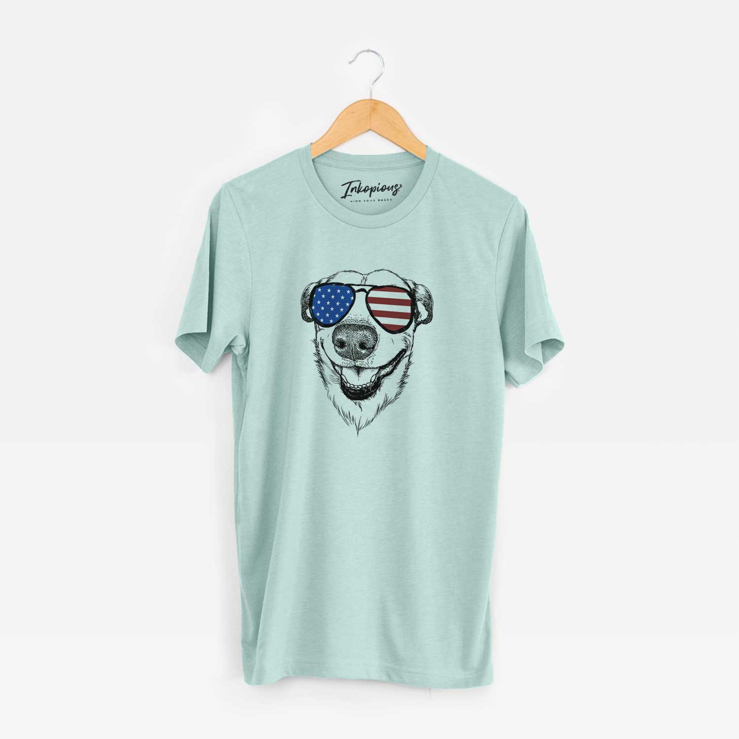 Hand-drawn sketch of Petrah the Staffy Mix wearing American flag sunglasses on a Heather Sage Unisex crewneck
