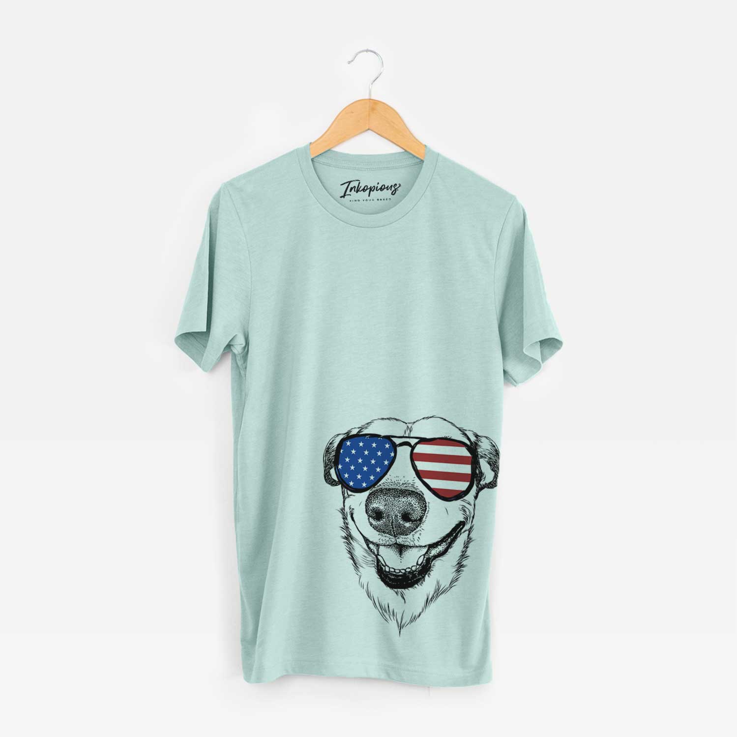 Hand-drawn sketch of Petrah the Staffy Mix wearing American flag sunglasses on a Heather Sage Unisex crewneck