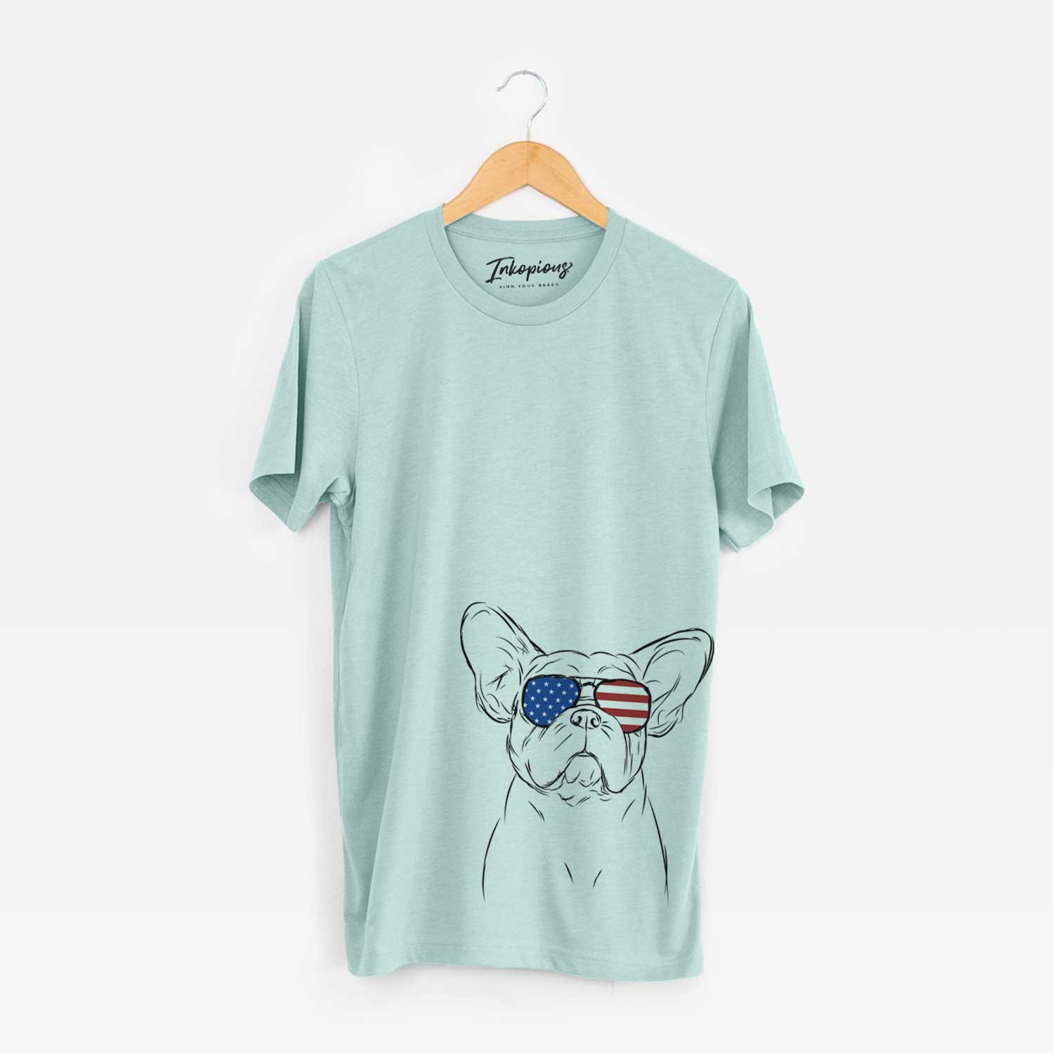 Hand-drawn sketch of Pierre the French Bulldog wearing American flag sunglasses on a Heather Sage Unisex crewneck