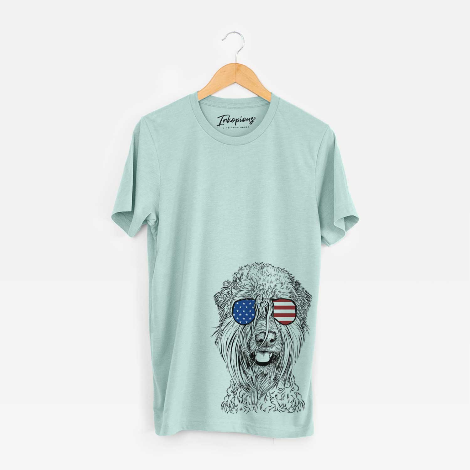 Hand-drawn sketch of Pierre the Soft Coated Wheaten Terrier wearing American flag sunglasses on a Heather Sage Unisex crewneck