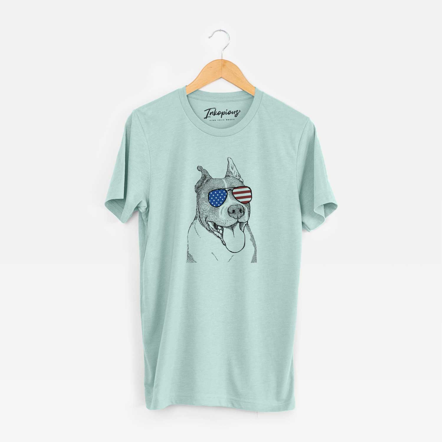Hand-drawn sketch of Piggy the American Staffordshire Terrier wearing American flag sunglasses on a Heather Sage Unisex crewneck