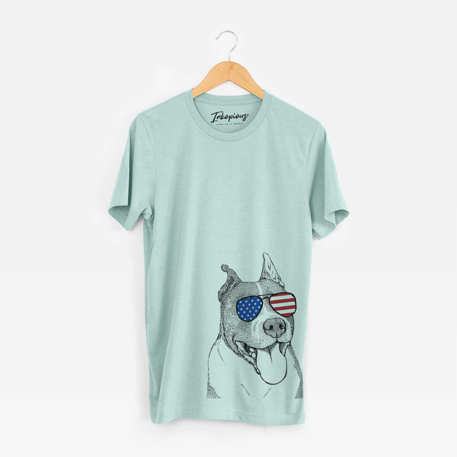 Hand-drawn sketch of Piggy the American Staffordshire Terrier wearing American flag sunglasses on a Heather Sage Unisex crewneck