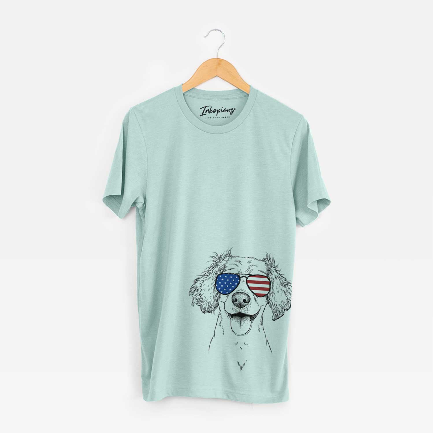 Hand-drawn sketch of Piglet the Dachshund Mix wearing American flag sunglasses on a Heather Sage Unisex crewneck