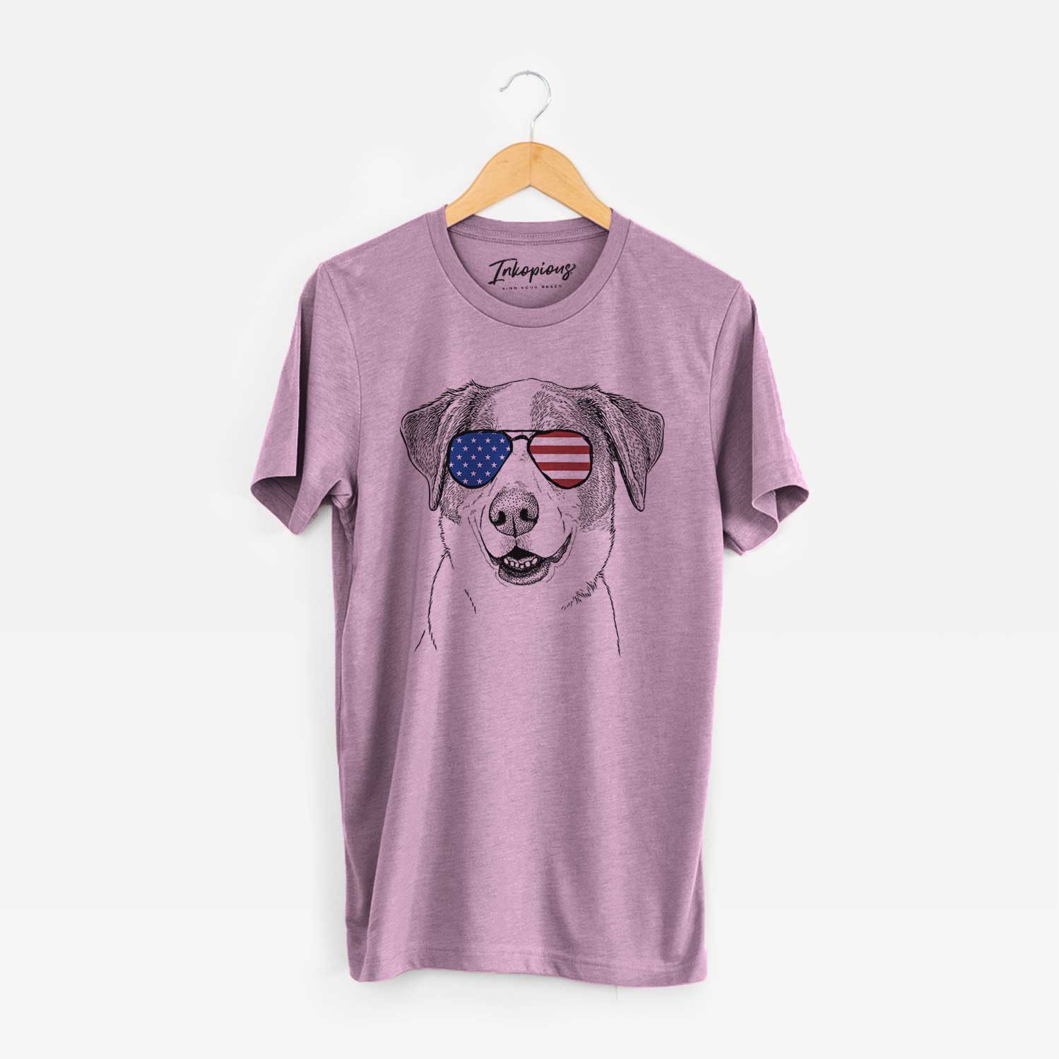 Hand-drawn sketch of Piper Pilot the Hound Mix wearing American flag sunglasses on an Orchid Unisex crewneck