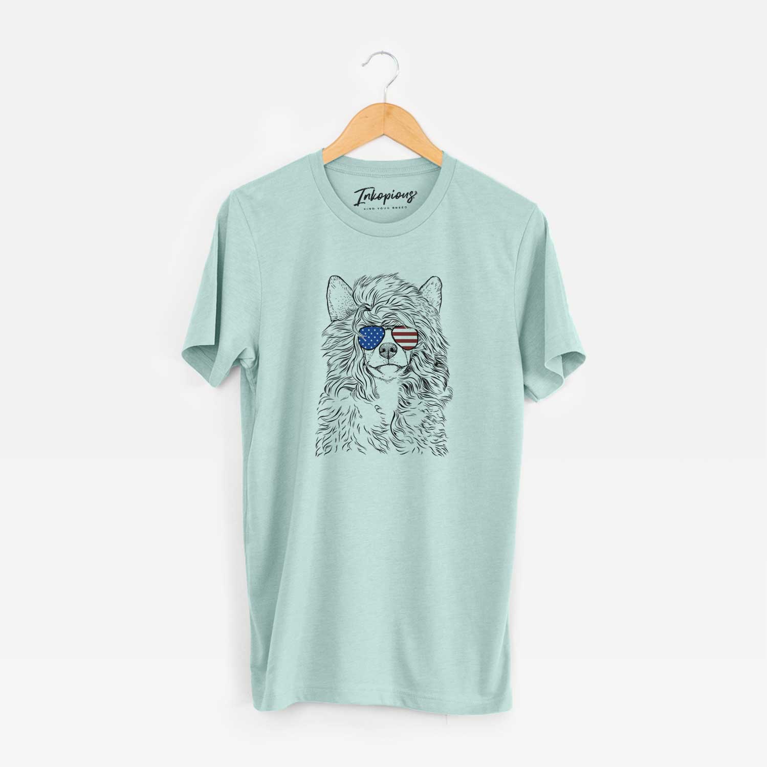 Hand-drawn sketch of Preston the Powderpuff Chinese Crested wearing American flag sunglasses on a Heather Sage Unisex crewneck