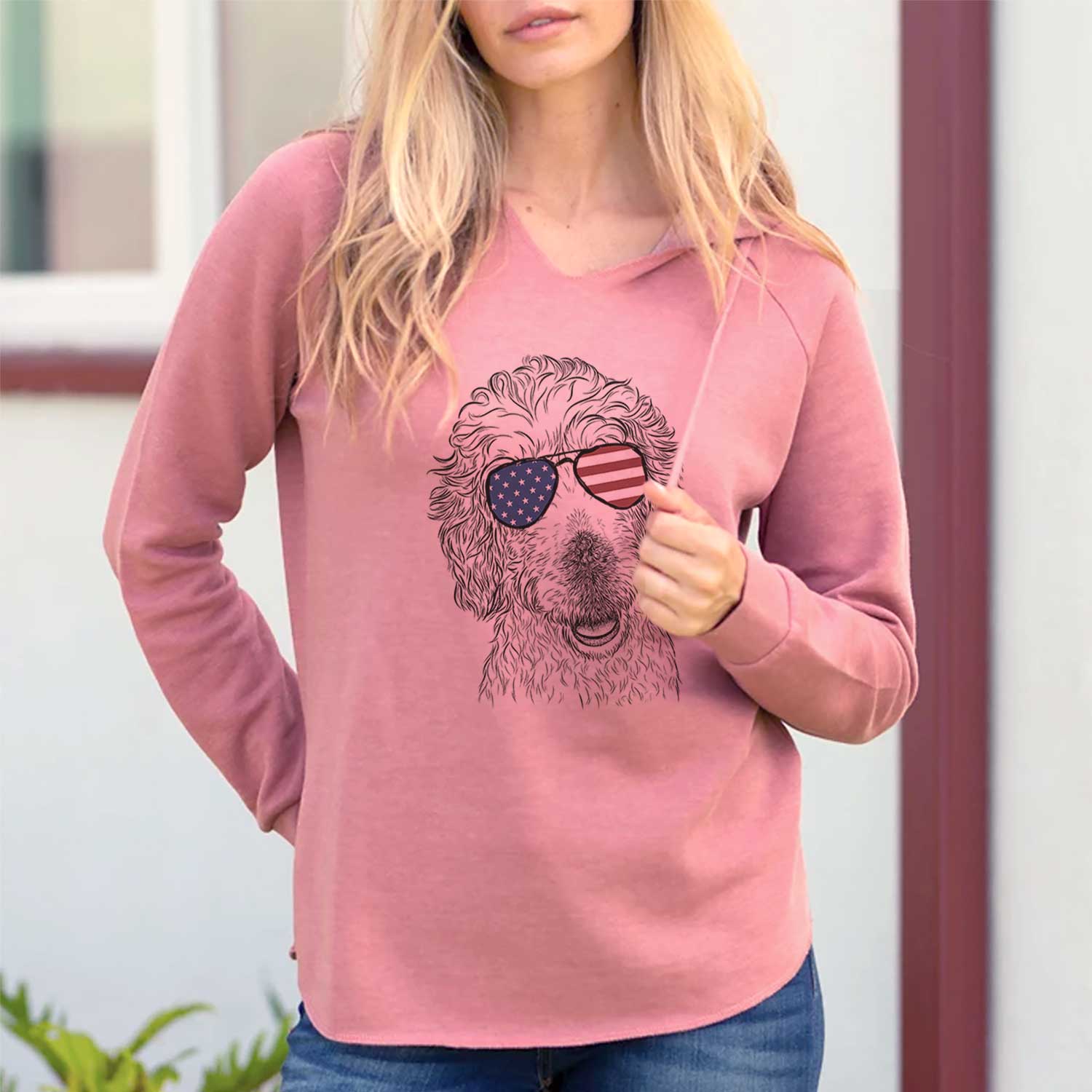 Hand-drawn sketch of Preston the Labradoodle wearing American flag sunglasses on a Dusty Rose Cali Wave Hooded Sweatshirt, lifestyle photo