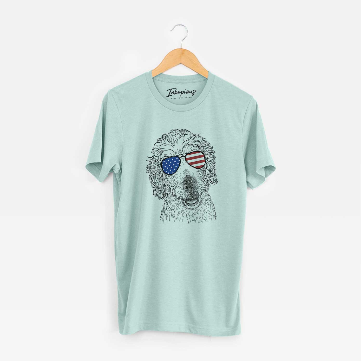 Hand-drawn sketch of Preston the Labradoodle wearing American flag sunglasses on a Heather Sage Unisex crewneck