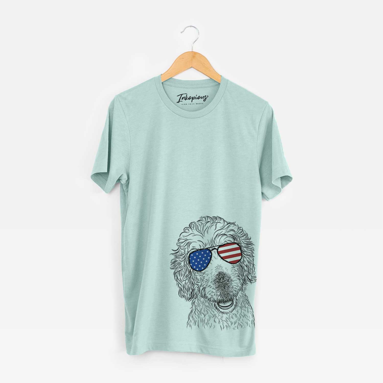 Hand-drawn sketch of Preston the Labradoodle wearing American flag sunglasses on a Heather Sage Unisex crewneck