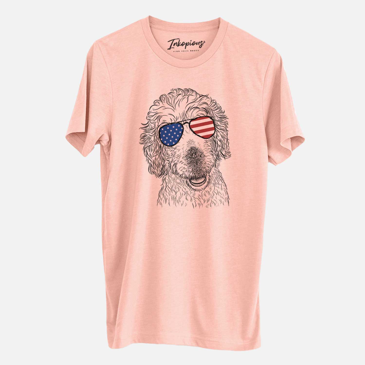 Hand-drawn sketch of Preston the Labradoodle wearing American flag sunglasses on a Peach Unisex crewneck