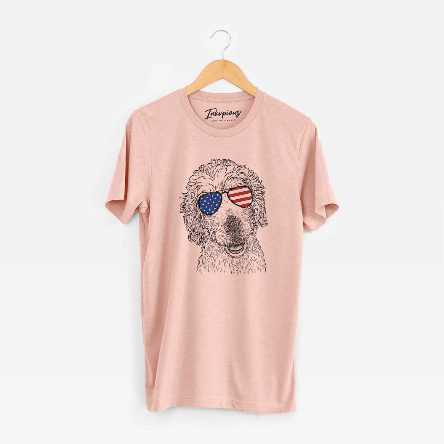 Hand-drawn sketch of Preston the Labradoodle wearing American flag sunglasses on a Peach Unisex crewneck